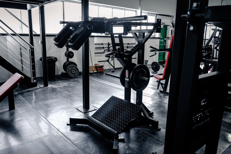 Plate-loaded standing calf raise machine at Strength Factory