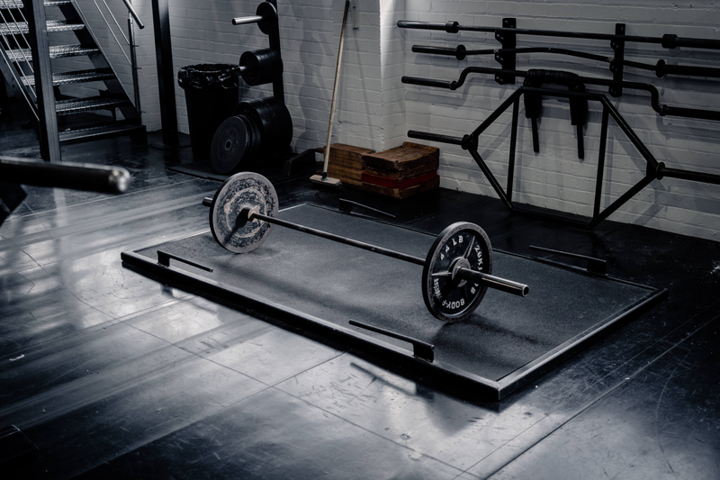 Deadlift platform with a loaded barbell at Strength Factory, Westhoughton