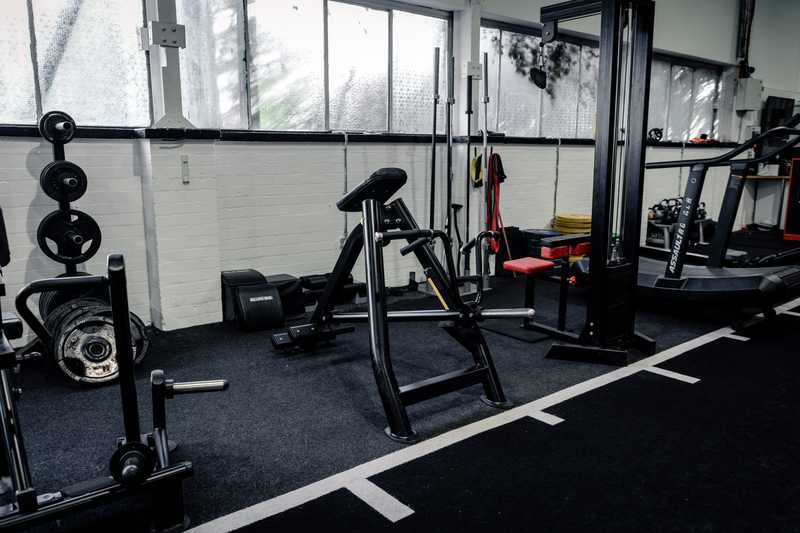Functional training area with plate-loaded row machines at Strength Factory, Bolton