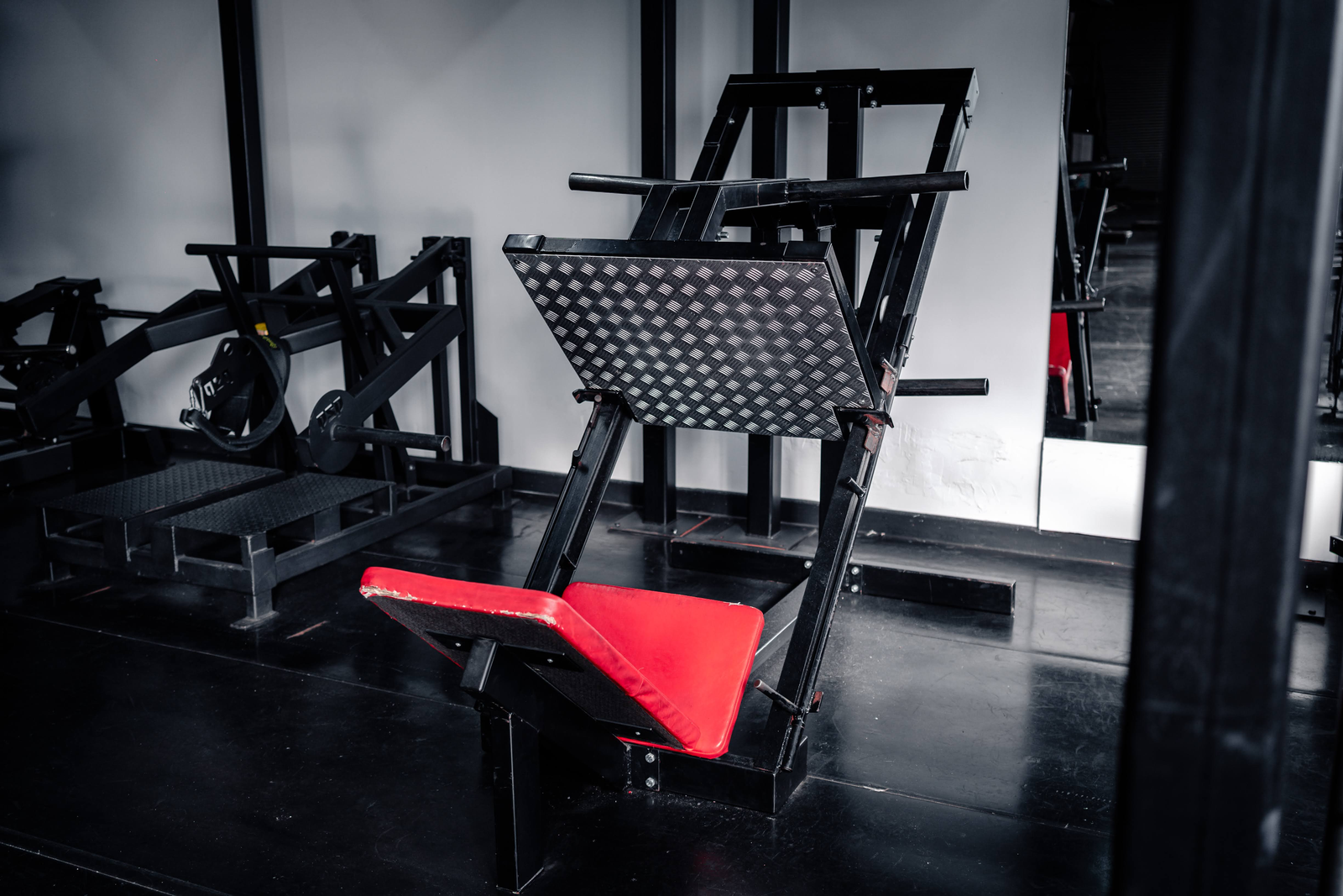 Plate-loaded leg press with red seat pad at Strength Factory, Bolton